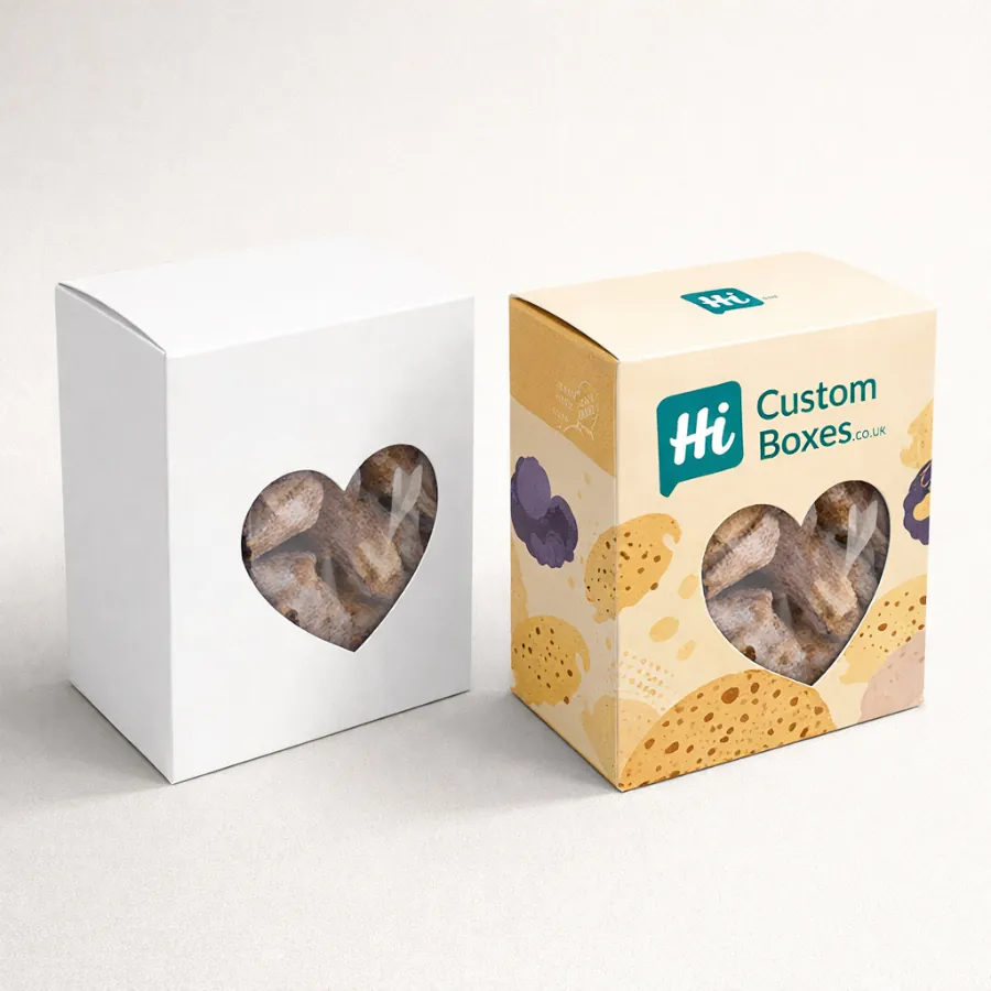 Two biscuit gift boxes featuring a heart-shaped window- with one box displaying a cream pattern- class=